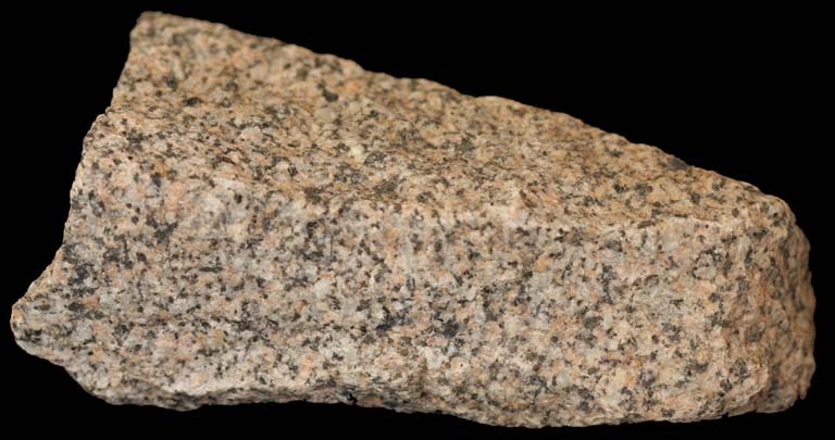 Colour image of rock speckled with black, white, pink, green and gray