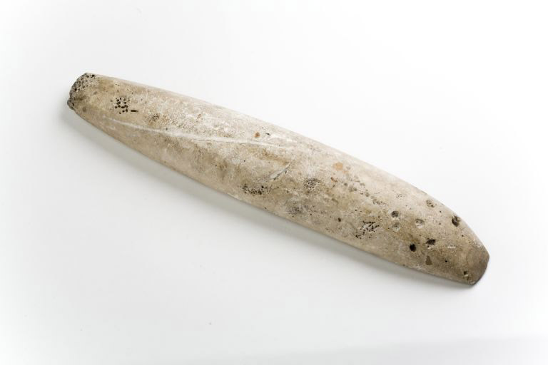 Colour image of long, narrow stone tool