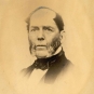 Black and white photograph of man in a suit with side whiskers