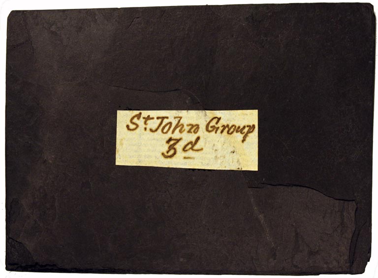 Colour image of black rock with paper label