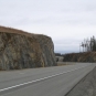 Colour photograph of rocky outcrop and highway